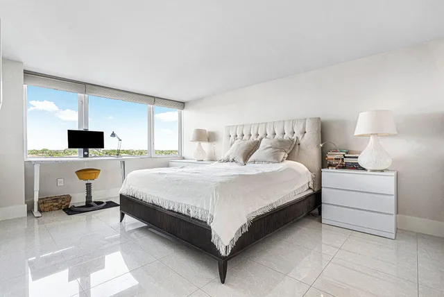 a bed room with a bed and a chair