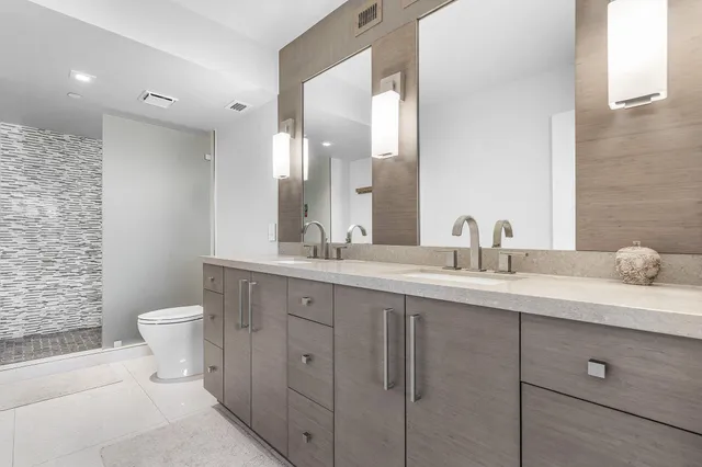 a bathroom with a toilet a sink and mirror
