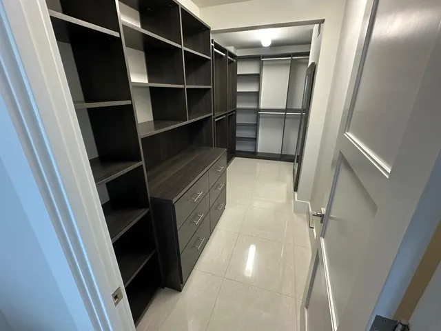 a view of walk in closet with empty racks