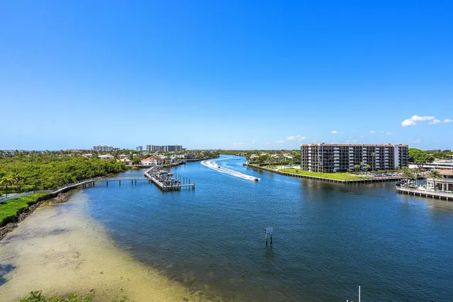 a view of a lake with boats and trees in the background