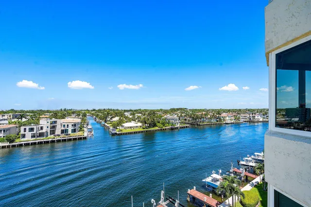 a living room with furniture couches and a dining table with garden view