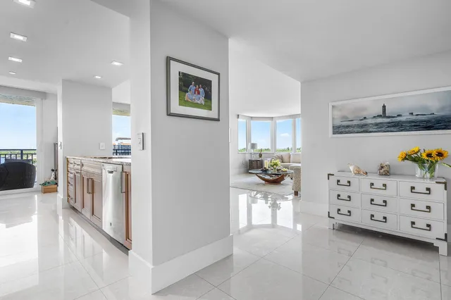 a large white kitchen with cabinets