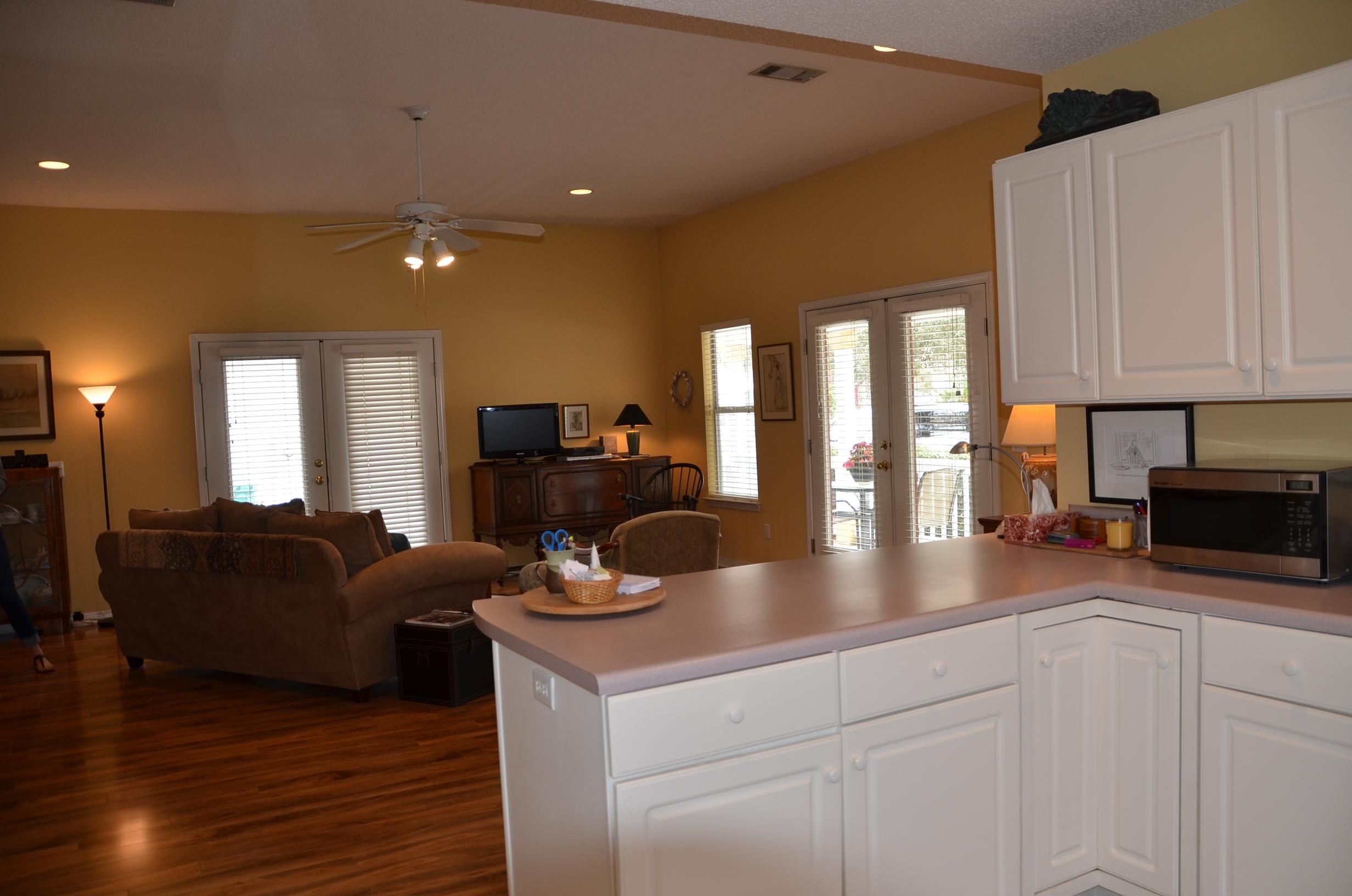 4456 Clipper Cove Destin, FL 32541 - Photo 11 of 31 a kitchen with stainless steel appliances granite countertop a sink a stove and a wooden floors