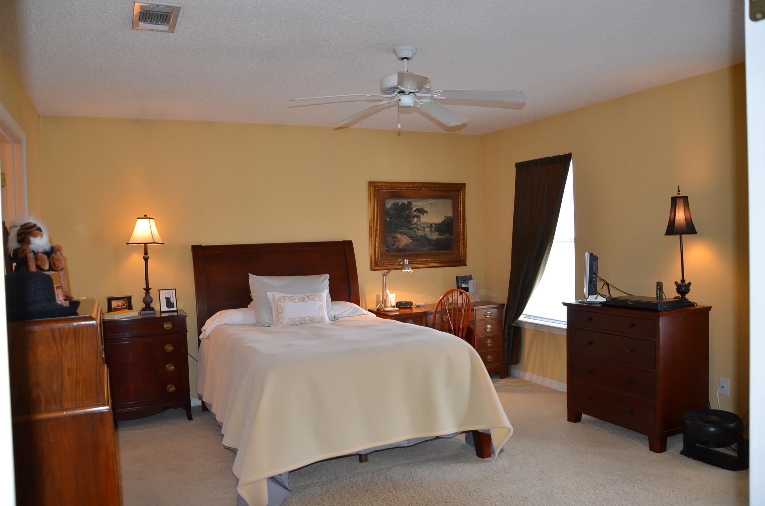 4456 Clipper Cove Destin, FL 32541 - Photo 12 of 31 a bedroom with a bed and a flat tv screen on dresser