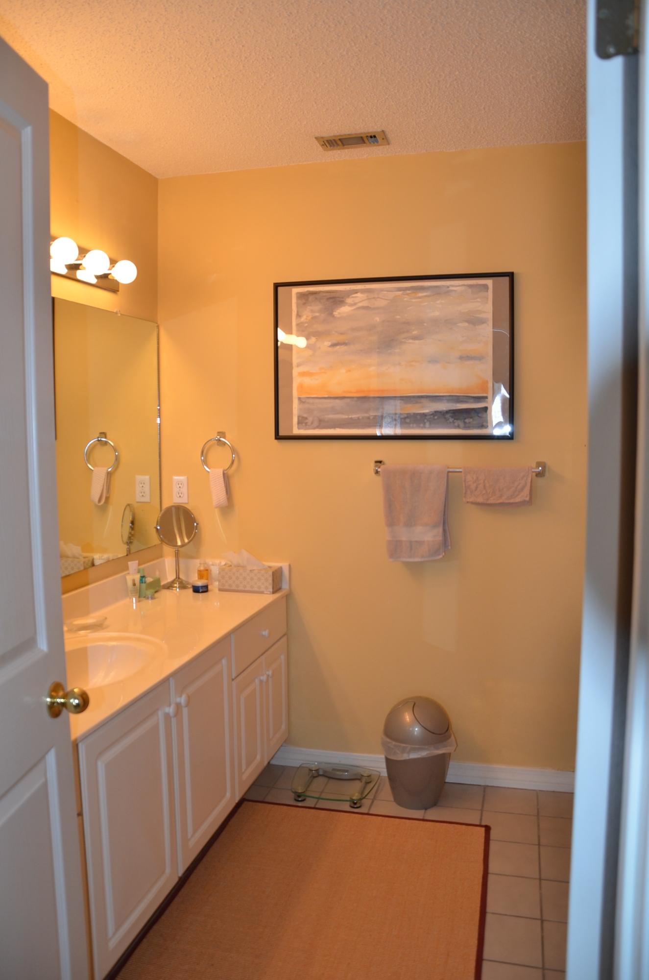 4456 Clipper Cove Destin, FL 32541 - Photo 14 of 31 a bathroom with a sink a toilet and mirror
