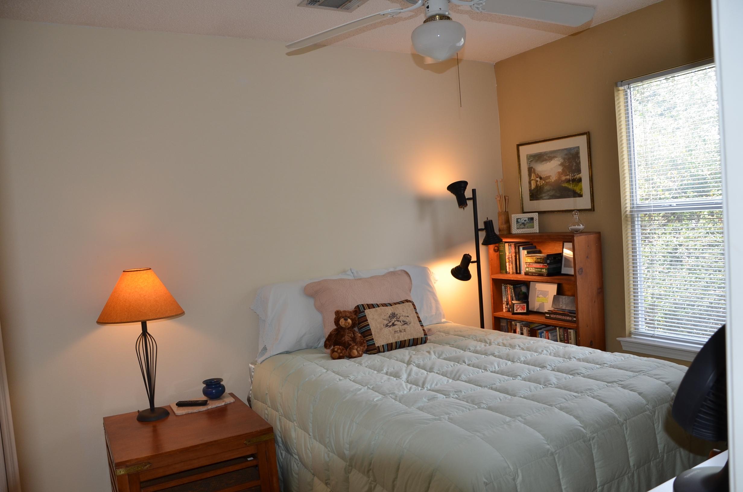 4456 Clipper Cove Destin, FL 32541 - Photo 15 of 31 a bedroom with a bed and a chandelier