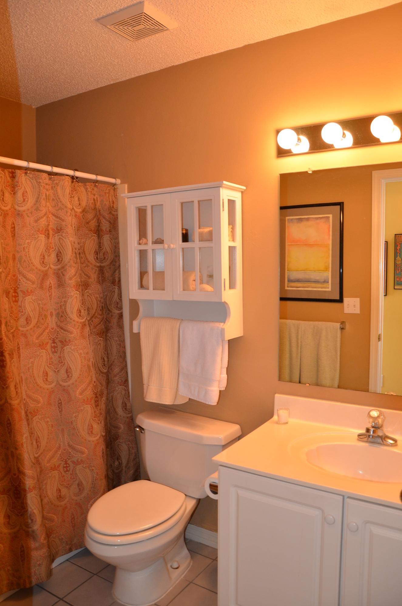 4456 Clipper Cove Destin, FL 32541 - Photo 16 of 31 a bathroom with a sink a toilet and shower