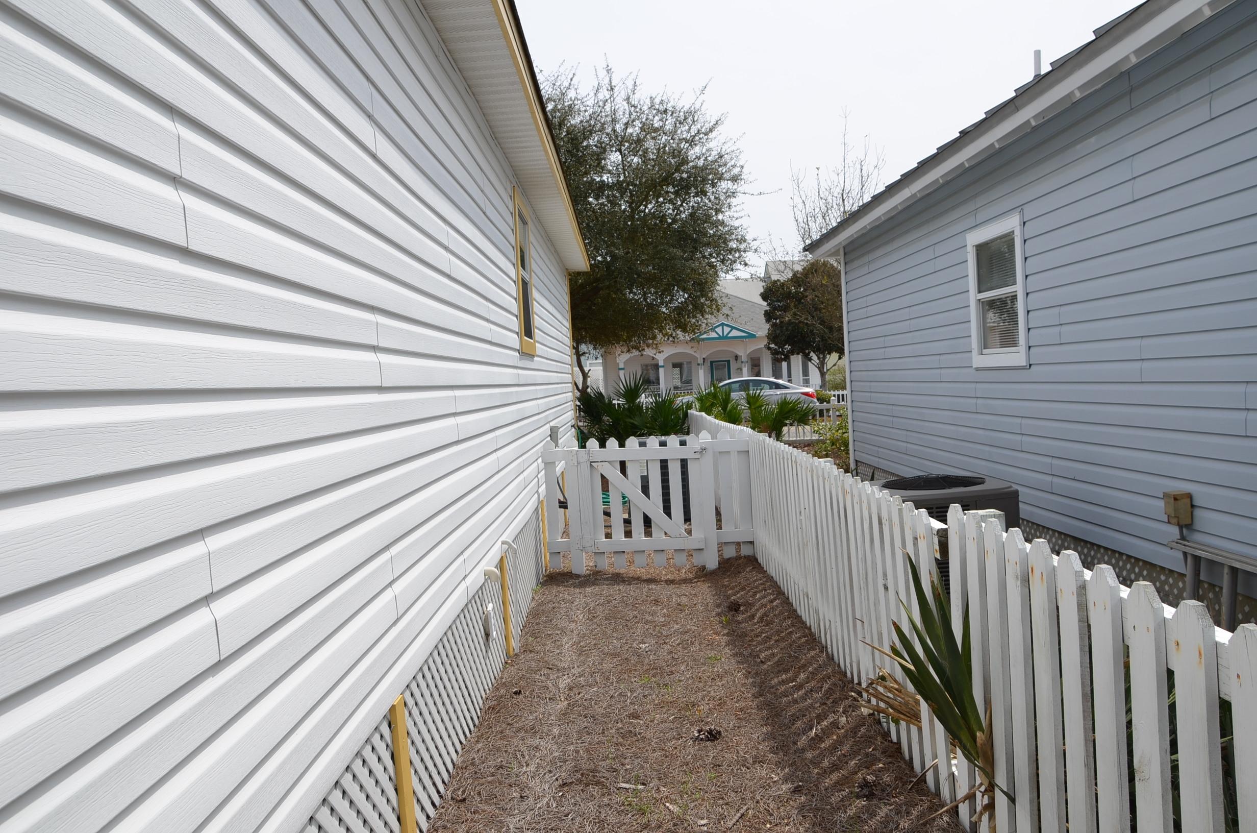4456 Clipper Cove Destin, FL 32541 - Photo 20 of 31 a view of a balcony with wooden floor and fence