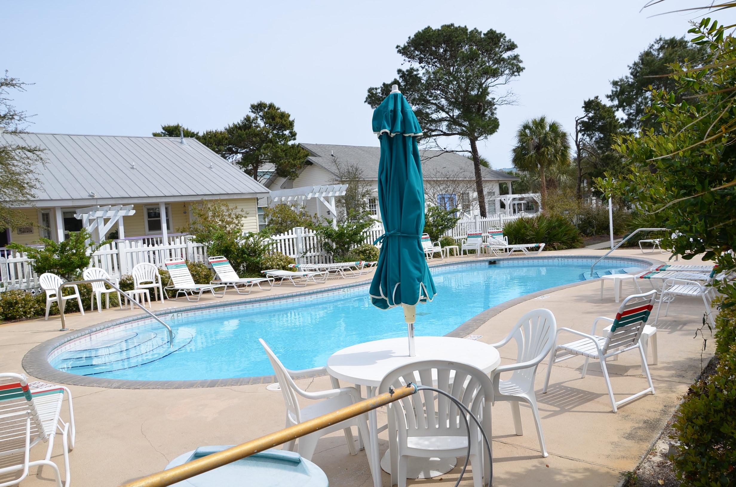 4456 Clipper Cove Destin, FL 32541 - Photo 28 of 31 a view of a swimming pool with outdoor seating and plants