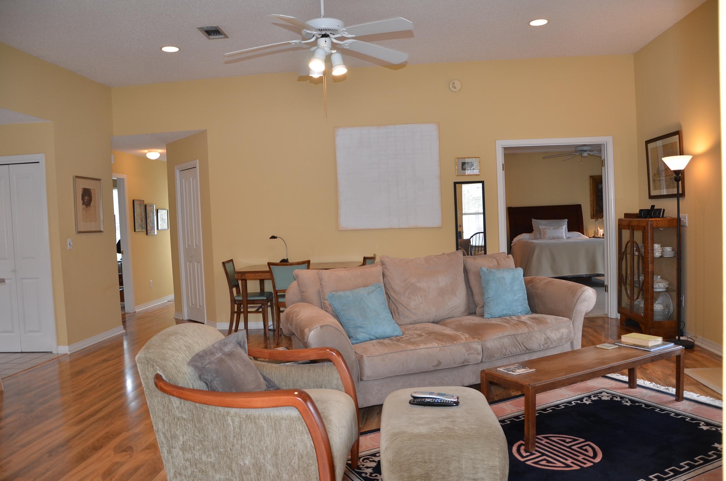4456 Clipper Cove Destin, FL 32541 - Photo 4 of 31 a living room with furniture and a lamp