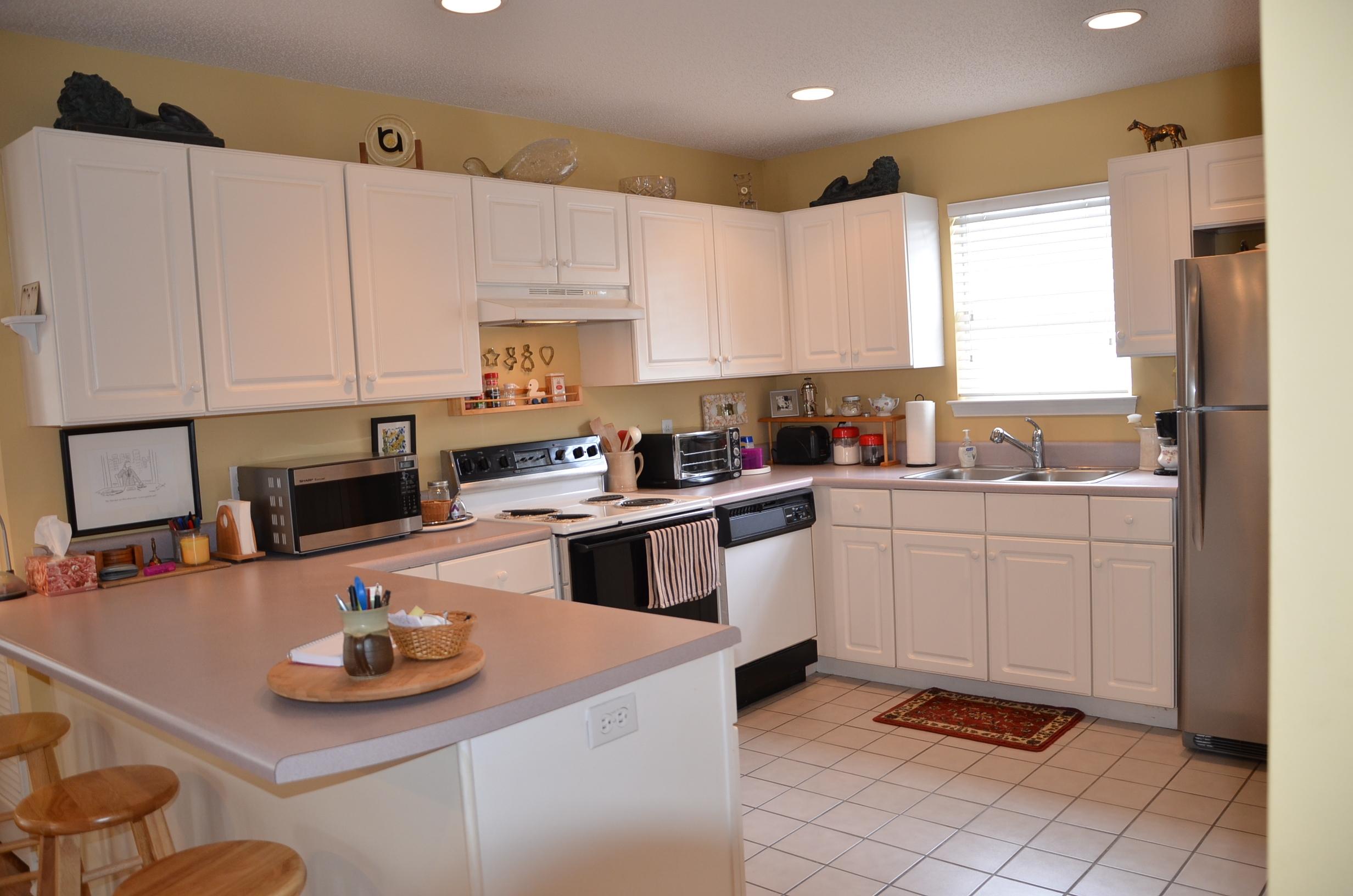 4456 Clipper Cove Destin, FL 32541 - Photo 8 of 31 a kitchen with granite countertop a sink stove and cabinets