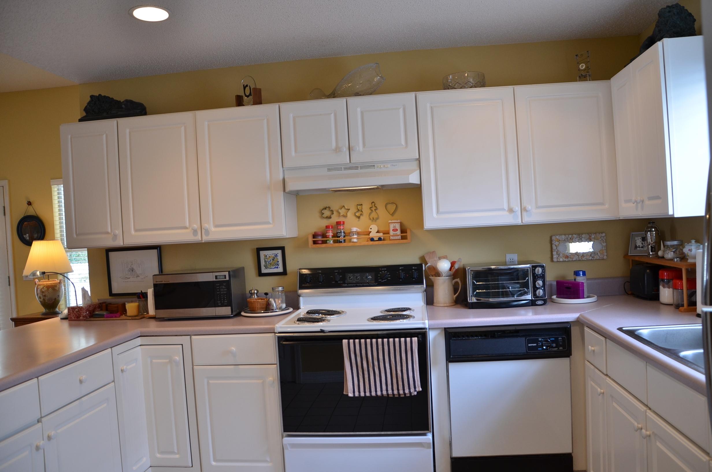 4456 Clipper Cove Destin, FL 32541 - Photo 9 of 31 a kitchen with white cabinets and white appliances