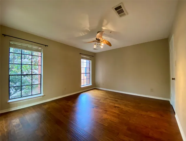 a view of an empty room with windows