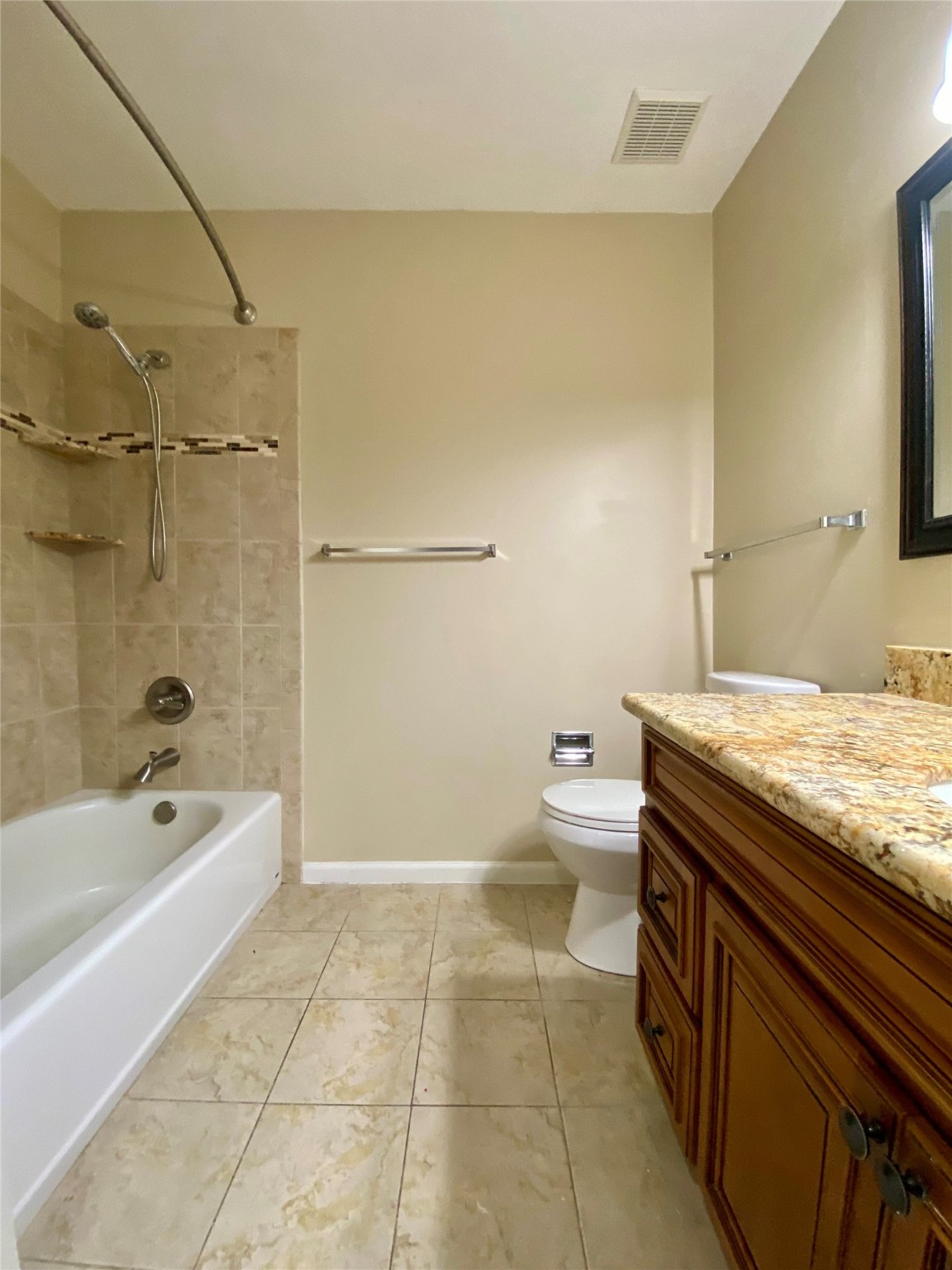 752 Augusta Drive Houston, TX 77057 - Photo 22 of 39 a bathroom with a granite countertop sink a toilet and bathtub