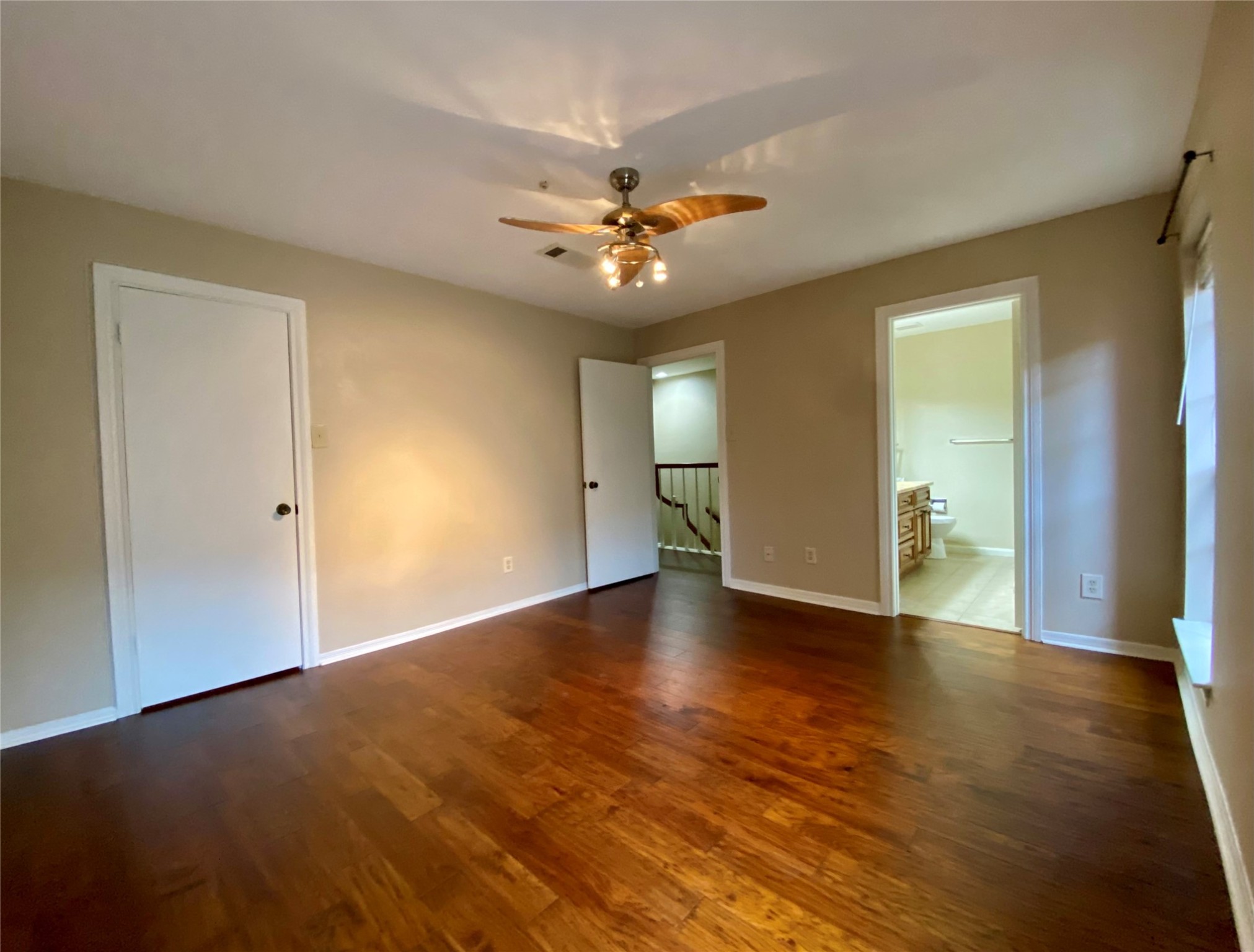 752 Augusta Drive Houston, TX 77057 - Photo 24 of 39 an empty room with wooden floor and a ceiling fan