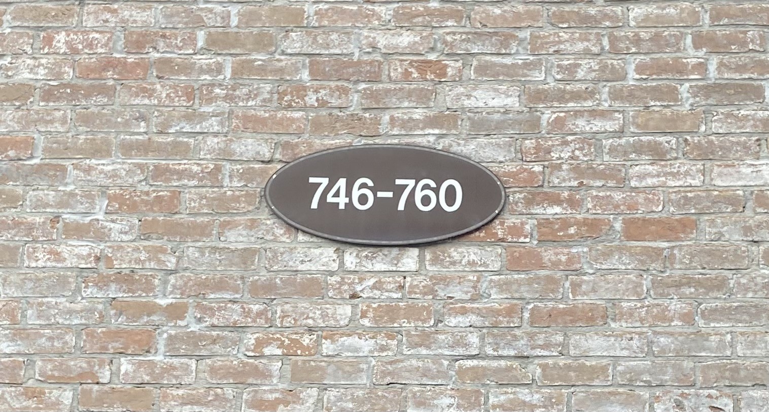 752 Augusta Drive Houston, TX 77057 - Photo 34 of 39 a sign on a brick wall
