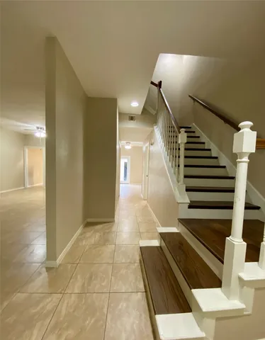 a view of entryway and hall with wooden floor