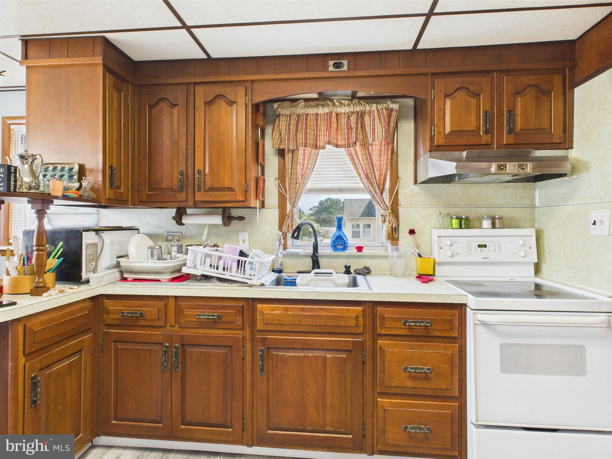 1207 Orems Road Baltimore, MD 21220 - Photo 7 of 33 a kitchen with stainless steel appliances granite countertop a sink window and cabinets