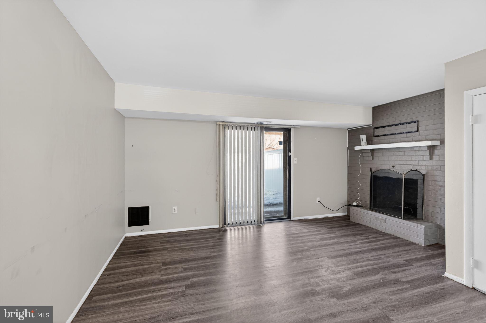 285 Via Cascata Drive Clementon, NJ 08021 - Photo 8 of 15 a view of an empty room with wooden floor fireplace and a window