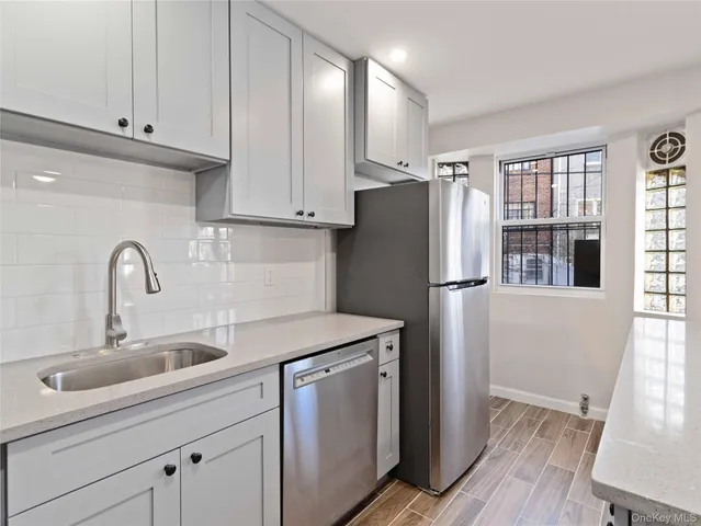 a kitchen with stainless steel appliances a refrigerator sink and cabinets