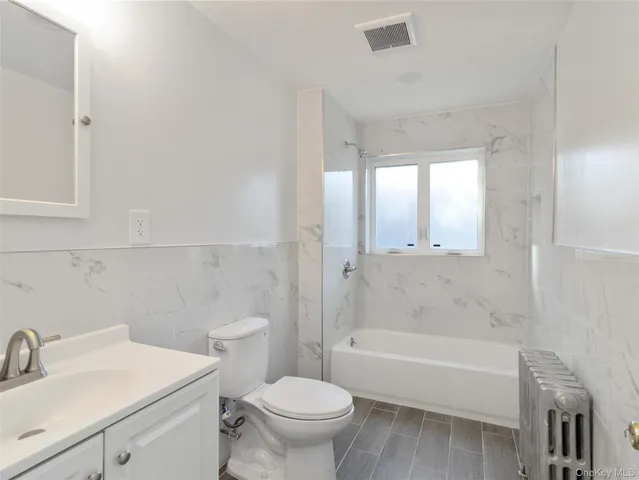 a bathroom with a sink toilet and bathtub