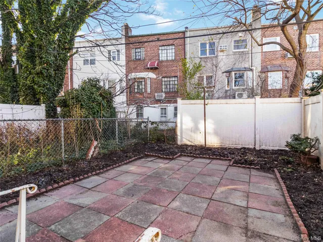 a view of a brick house with a yard