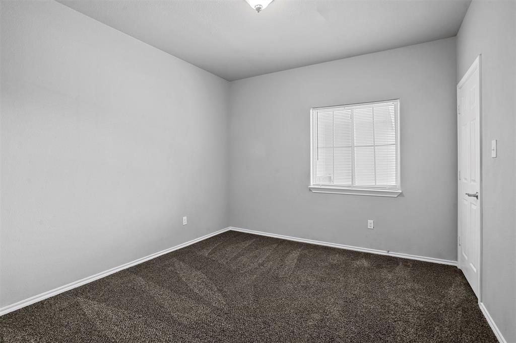 609 Meadow View Court, Unit 102 Denton, TX 76207 - Photo 9 of 13 an empty room with a window