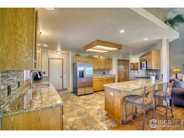 a large kitchen with a table and chairs