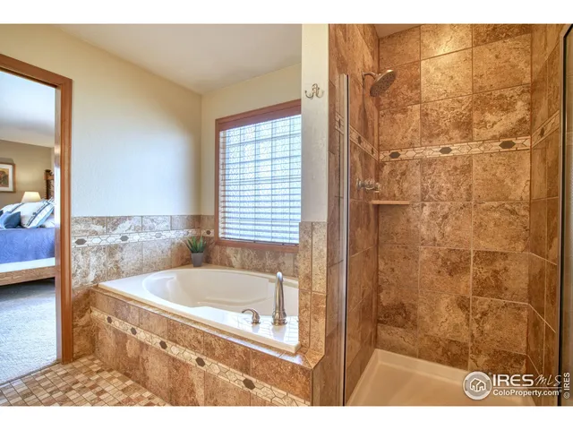 a bathroom with a tub and shower