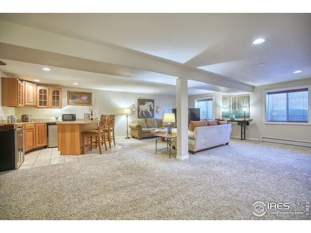 a living room with furniture and a kitchen