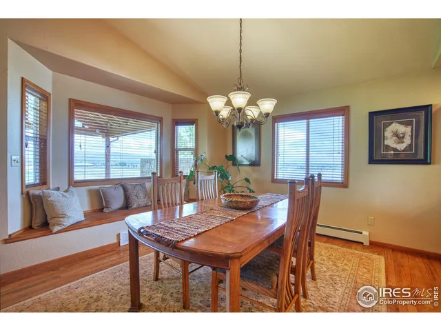 a dining room with furniture a rug and a chandelier