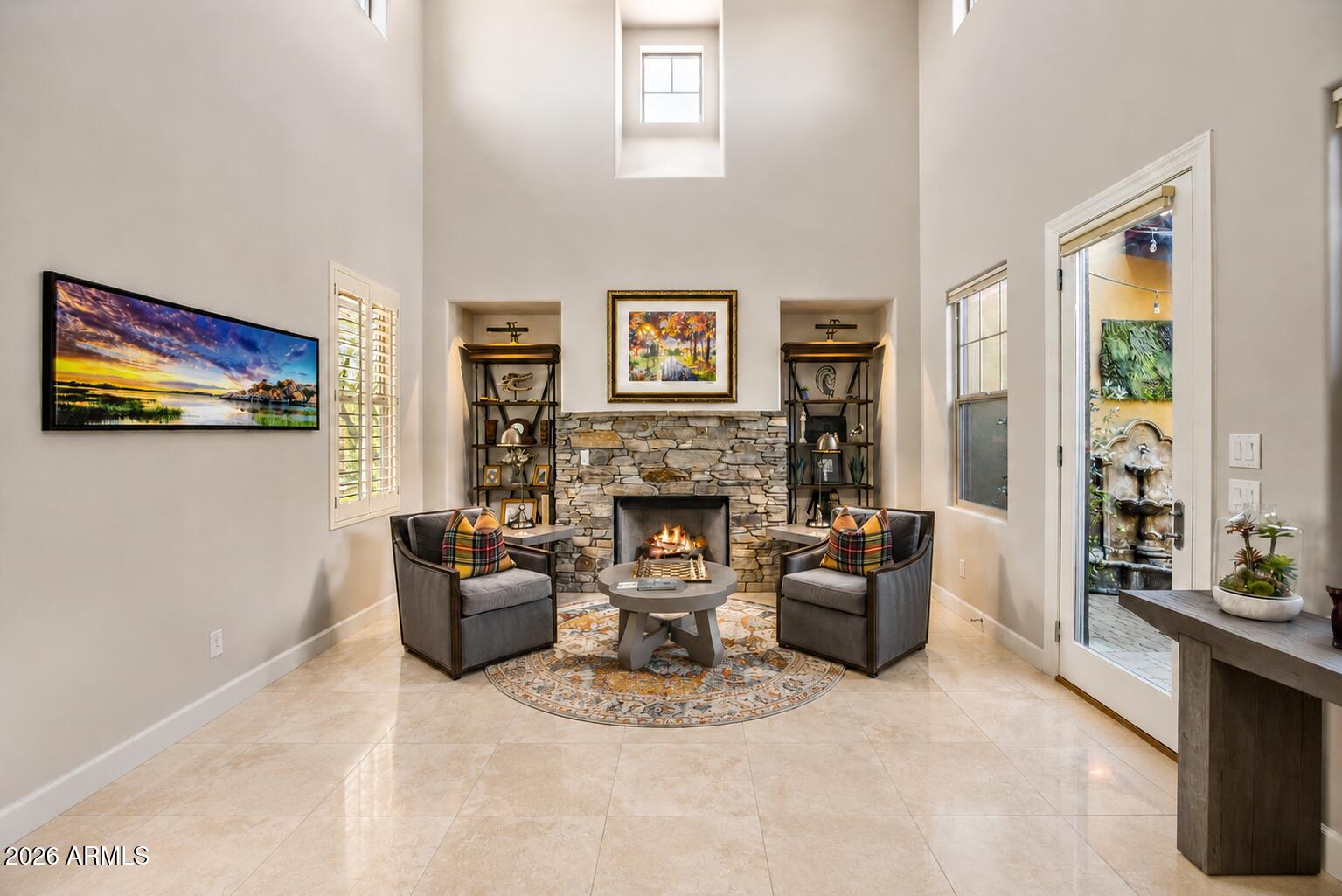 9488 East Canyon View Road Scottsdale, AZ 85255 - Photo 11 of 38 a living room with furniture a flat screen tv and a fireplace
