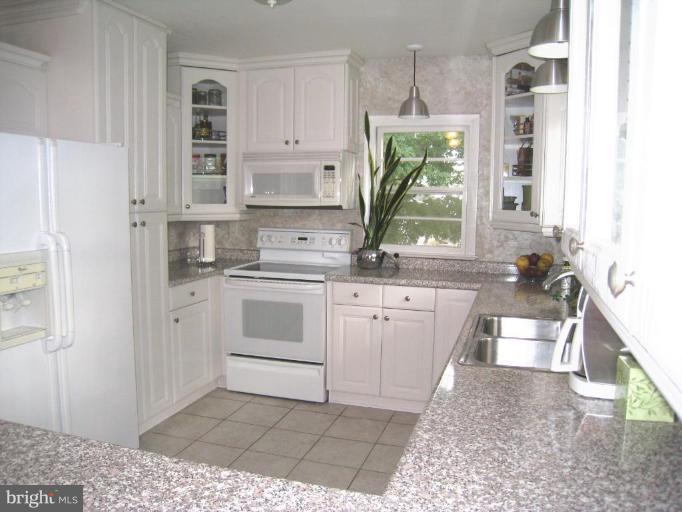 315 Hampton Road Linthicum Heights, MD 21090 - Photo 2 of 22 a kitchen with a white stove top oven and sink