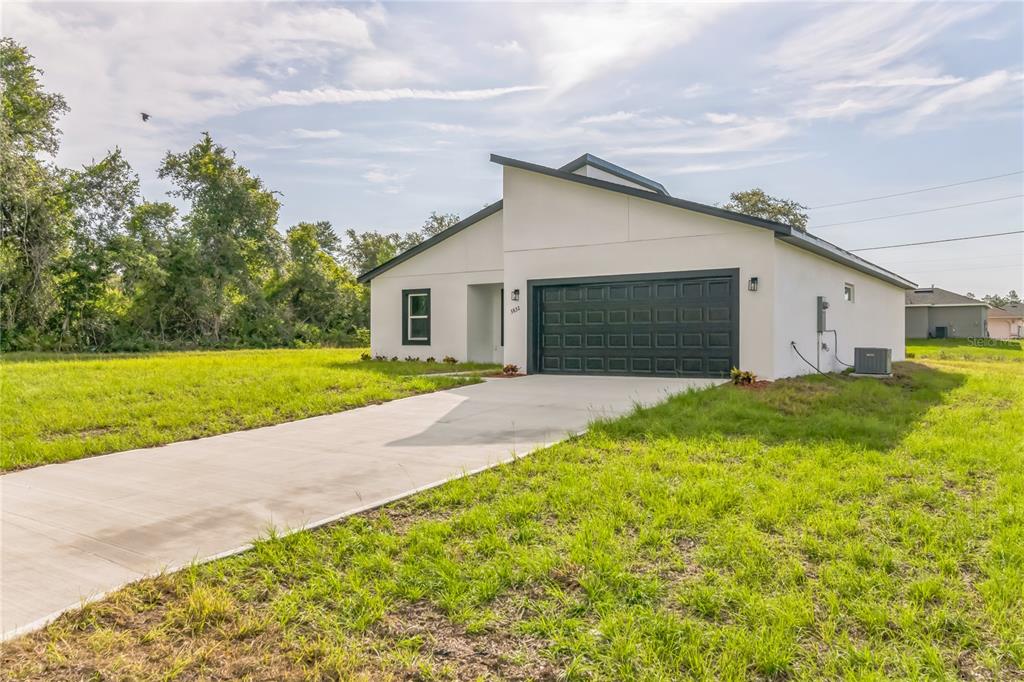 a front view of house with yard and green space