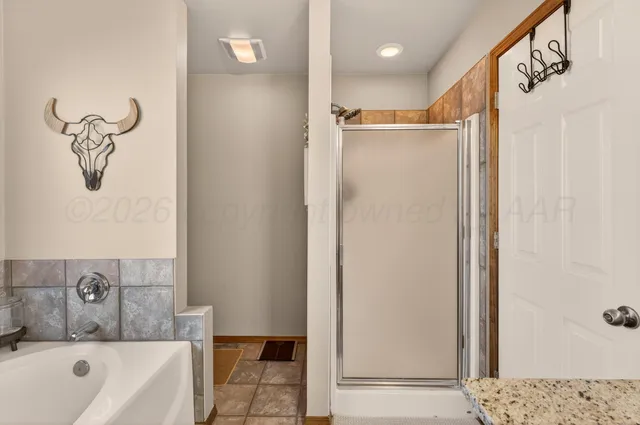 a bathroom with a bathtub a shower and a sink