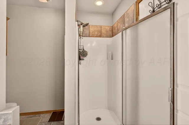 a bathroom with a shower and a sink