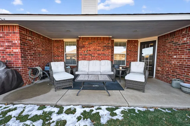 a outdoor living space with furniture and rug