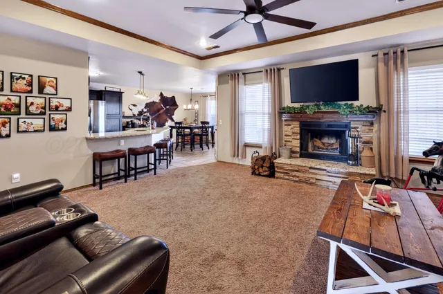 a living room with furniture a fireplace and a flat screen tv