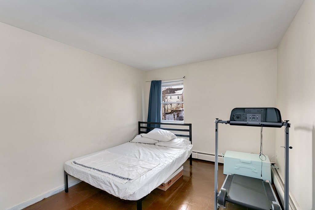 46 Adams Street, Unit C1 Boston, MA 02122 - Photo 11 of 13 a bedroom with a bed and window