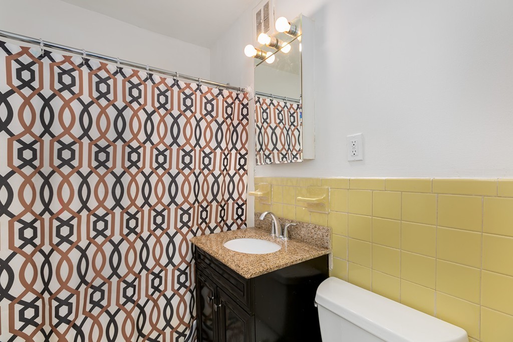 46 Adams Street, Unit C1 Boston, MA 02122 - Photo 12 of 13 a bathroom with a sink a toilet and a mirror