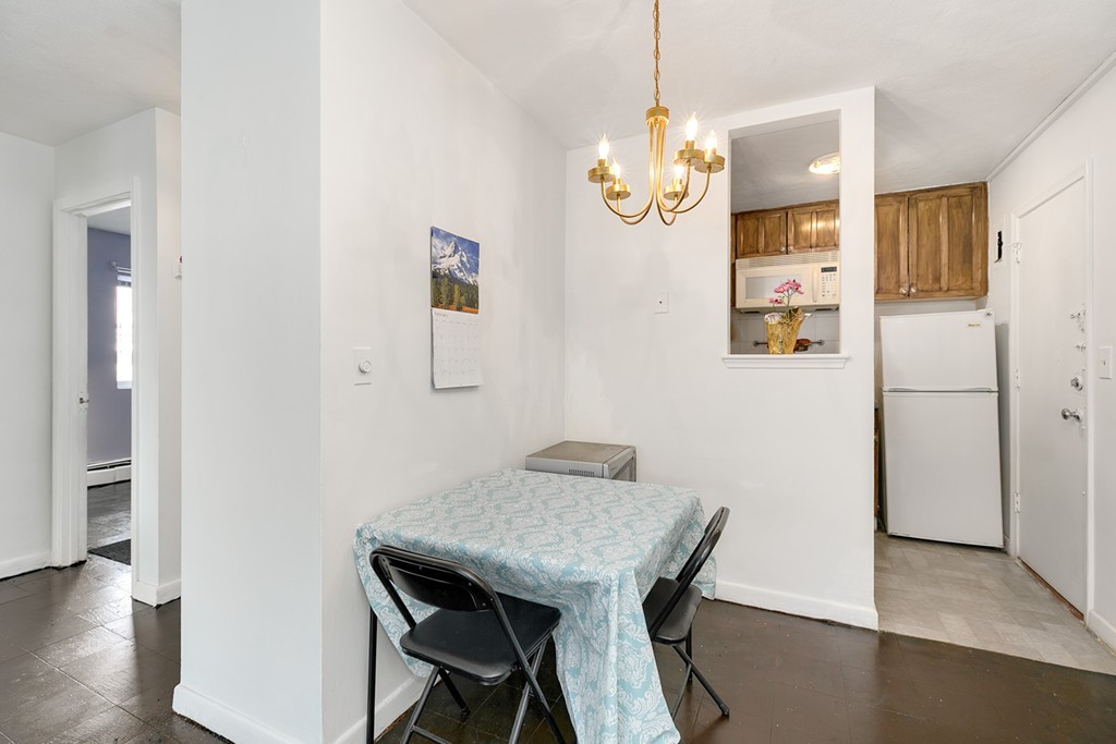 46 Adams Street, Unit C1 Boston, MA 02122 - Photo 4 of 13 a view of a dining area with furniture and wooden floor