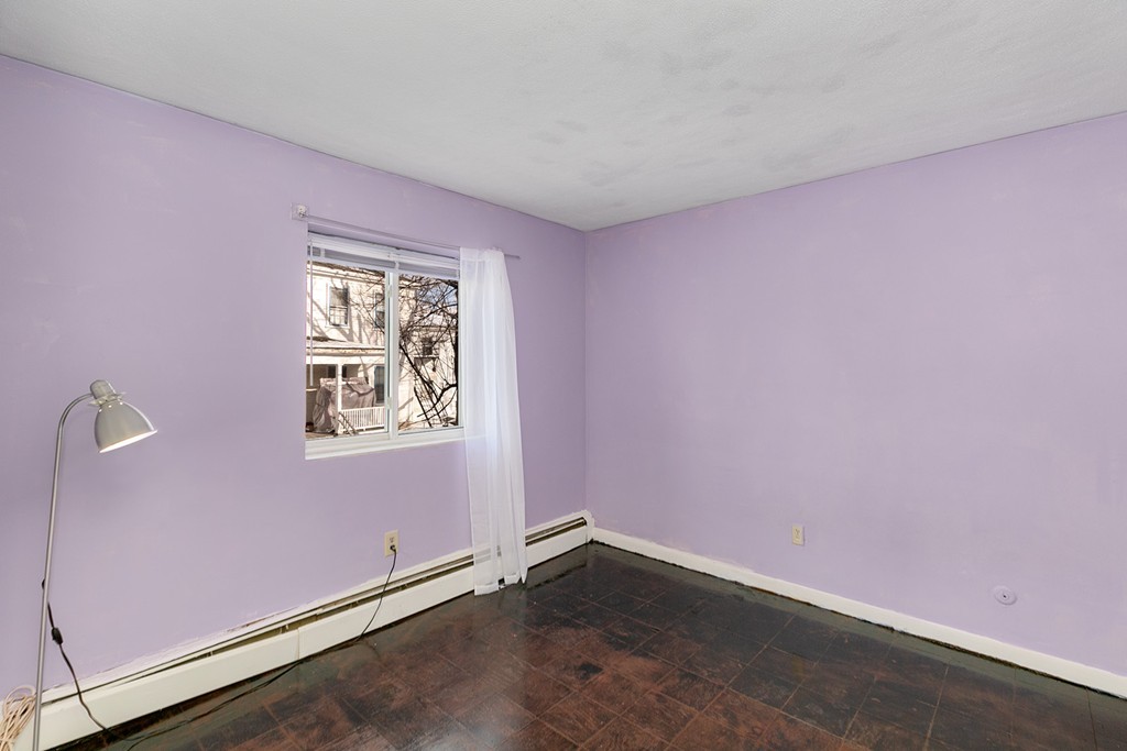46 Adams Street, Unit C1 Boston, MA 02122 - Photo 5 of 13 an empty room with windows
