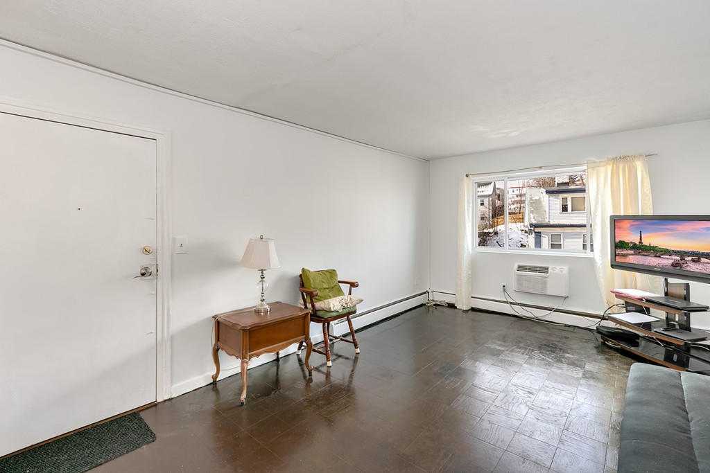 46 Adams Street, Unit C1 Boston, MA 02122 - Photo 6 of 13 a living room with furniture a rug and a window