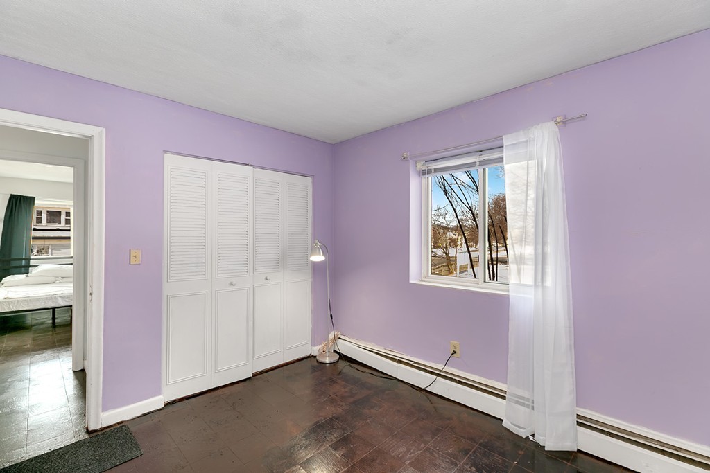 46 Adams Street, Unit C1 Boston, MA 02122 - Photo 9 of 13 an empty room with windows