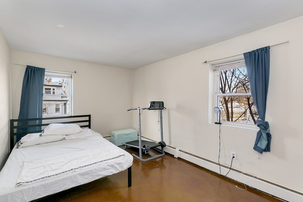 46 Adams Street, Unit C1 Boston, MA 02122 - Photo 10 of 13 a bedroom with a bed and a window