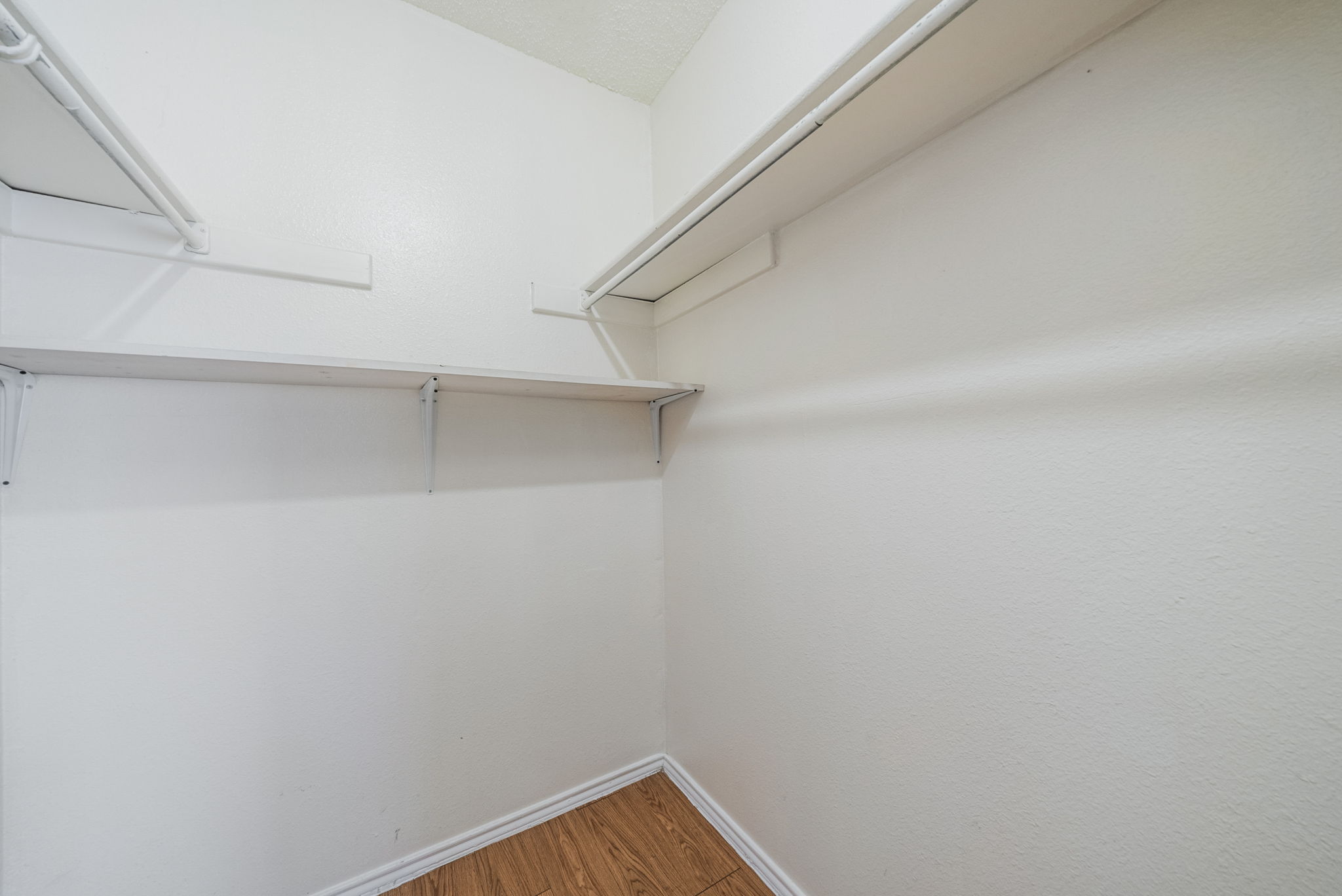 5807 Spring Meadow Road, Unit B Austin, TX 78744 - Photo 28 of 31 Ample closet space with sturdy shelving offers practical organization for any wardrobe.
