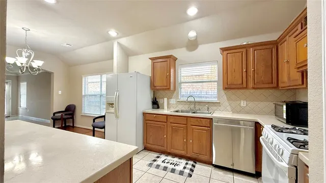 a kitchen with stainless steel appliances a sink stove and refrigerator