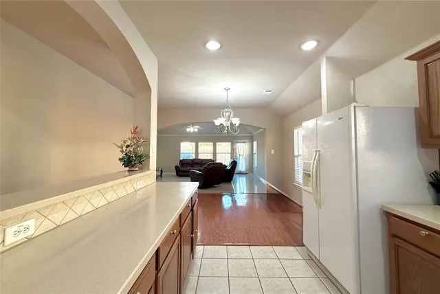 a large white kitchen with a large window