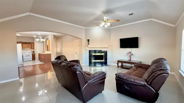 a living room with furniture a fireplace and a flat screen tv