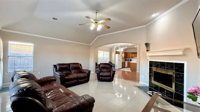 a living room with furniture a fireplace and a flat screen tv